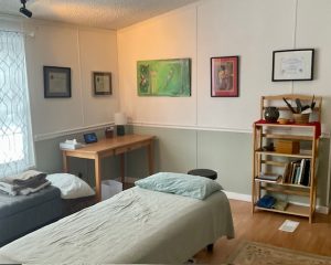Photo of studio showing lift table, bookshelf, and desk.
